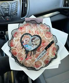 a car dashboard with a cake in the shape of a heart and two girls on it