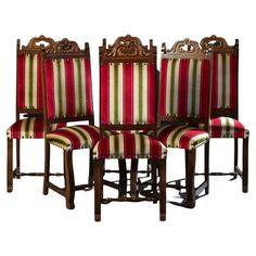 four chairs with striped upholstered back and arms