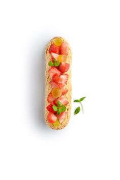 a piece of bread with fruit on it and leaves sticking out of the top half