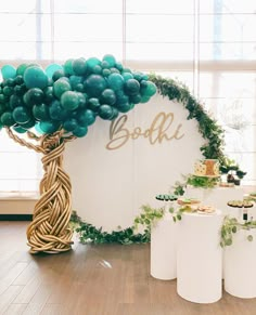 a table topped with lots of green balloons