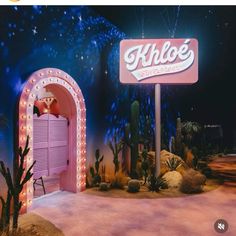 the entrance to khloe's las vegas is lit up in pink and white