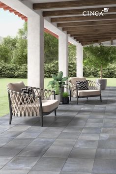 an outdoor seating area with chairs and potted plants