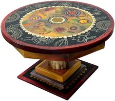 an ornate wooden table with painted designs on it