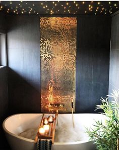 a bathtub with candles in it and lights on the wall