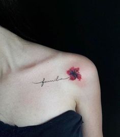 a woman with a red flower tattoo on her left shoulder and the word fragile written in cursive ink