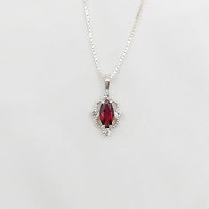 2.70ct .925 Sterling silver pendant featuring rhodolite garnet. >     2.10ct 12x6mm marquise natural rhodolite garnet. >     0.60ct (4) 3mm round lab-created white sapphire accent. >     Stone color may vary slightly from photo. >     18 Inch 1.15mm .925 Sterling silver box chain. >     Pendant measures 1 inch x 1/2 inch or 25mm x 13mm. >     Item packaged in velour gift box. Silver Ruby Necklace, Silver Ruby Heart Cut Necklace, Elegant Lab-created Ruby Pendant Jewelry, Silver Necklace With Lab-created Ruby Gemstone, Red Lab-created Ruby Pendant Jewelry, Red Heart-shaped Sterling Silver Charm Necklace, Ruby Necklace, Rhodolite Garnet, Sapphire Pendant