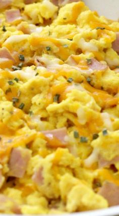 a white bowl filled with scrambled eggs and ham