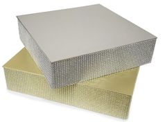 two silver and gold boxes stacked on top of each other