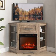 an entertainment center with a television and fire place