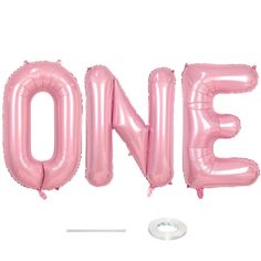 the word one is made out of pink foil balloons and sits in front of a white background