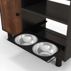 two bowls sit in front of a black cabinet