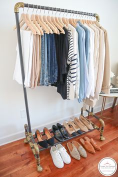 clothes and shoes are hanging on a rack