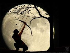 a woman holding up a bow while standing in front of a tree with the moon behind her