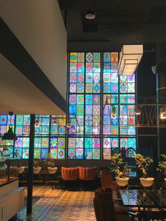 the interior of a restaurant with large stained glass windows