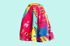 "levate your style with the Fiorucci Pink, Yellow, Mint, and Blue Pop Art Print Skirt, a vibrant and playful piece that brings the spirit of the 80s alive in your wardrobe. This skirt is a true work of art, designed to make you stand out and express your unique sense of fashion. Key Features: Inseam Pockets: Practical and stylish, this skirt is equipped with inseam pockets, offering convenience without compromising the silhouette. Vibrant Electrifying Pop Art Print: The skirt showcases an electrifying pop art print that's a homage to the iconic style of the 80s. With popping text like \"cruisin,\" television motifs, and bold numbers, it's a visual delight that's sure to turn heads. Skater Skirt Silhouette: The skater skirt silhouette is universally flattering, providing a comfortable fit a Retro Graphic Print Skirt For Spring, Pop Art Skirt, Multicolor Retro Stretch Skirt, Multicolor Retro Mini Skirt, Vibrant Multicolor Floral Print Skirt, 80s Pop Culture, Pop Art Print, Vintage Rock, Yellow Fabric