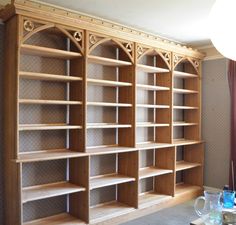 a large wooden bookcase in the corner of a room