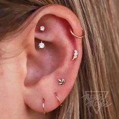 an ear with three different piercings on it