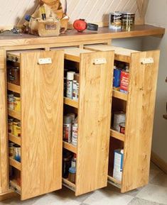 a wooden cabinet filled with lots of food and condiments on top of it