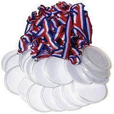 six plastic plates with red, white and blue ribbons on the top one is empty