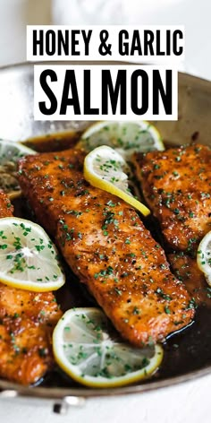 honey and garlic salmon in a pan with lemons