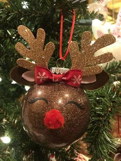 a christmas ornament hanging from a tree with reindeer's head on it