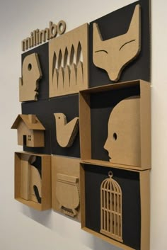 cardboard cutouts are arranged on the wall to look like birdcages and cages