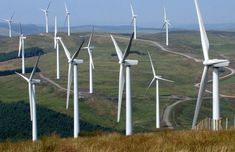 many windmills on the side of a hill