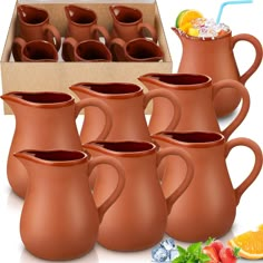 a set of six brown pitchers with strawberries and orange slices on the side, in front of a cardboard box