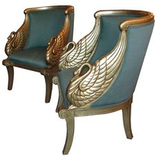 two blue chairs with gold accents on the back and arms, one is shaped like an eagle