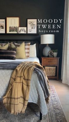 a bedroom with black walls and pictures on the wall above the bed, along with an area rug