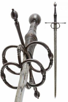 a metal sculpture with two swords attached to it