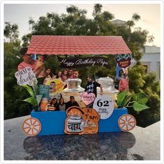 a birthday cake cart with people on it