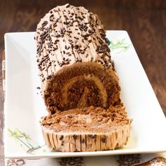 a loaf of chocolate cake sitting on top of a white plate