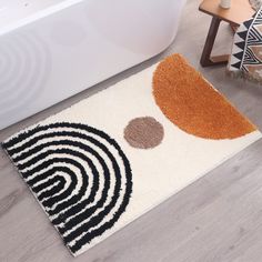 a bathroom rug with circles on it in front of a bathtub and toilet seat