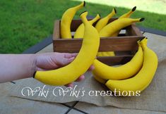 a person is holding some bananas on a table