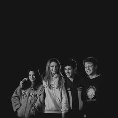 a group of people standing next to each other in front of a black background with the words brown on it