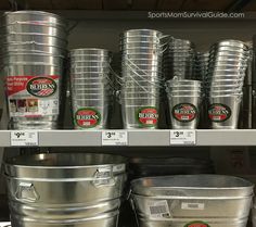 several buckets and containers are on display in a grocery store's cooler shelf