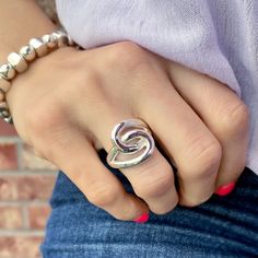 a woman's hand wearing a silver ring