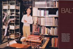 an older man standing in front of a book shelf filled with books