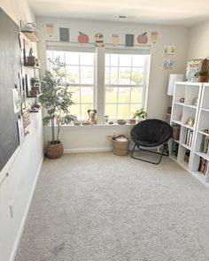 a living room with white walls and carpet