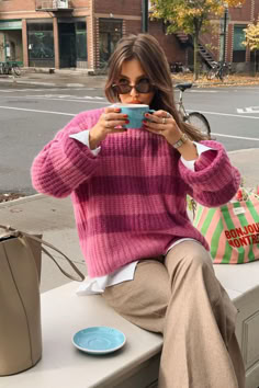 @audreyrivet is drinking a coffee while wearing Sézane Jose pink stripes jumper. Winter Outfits Knitted Sweater, Pattern Style Fashion, Preppy Boho Outfits Winter, Pastel Winter Outfit Classy, Pink Knitwear Outfit, Colorful Cool Outfits, Pink Knit Jumper Outfit, Colorful Sophisticated Outfits, Sezane Striped Sweater