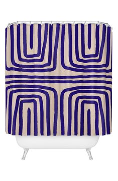 a blue and white shower curtain with an abstract design