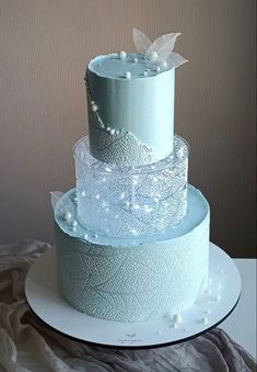 a three tiered cake sitting on top of a white plate