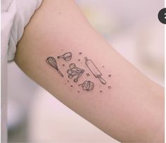 a woman's arm with an outline of kitchen utensils and baking implements on it