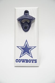 a bottle opener in the shape of a star with cowboys on it's side