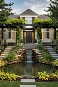 Elegant house with a black front door, a pergola adorned with greenery, a central waterfall, and lush garden landscaping. Drought Tolerant Trees, Low Maintenance Shrubs, Zen Garden Design, Low Maintenance Landscaping, Front Yard Landscaping Ideas, Yard Landscaping Ideas, Self Watering Planter, Rain Garden, Soil Improvement