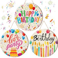 three happy birthday signs hanging from strings with confetti and candles on them,