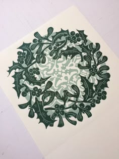 a green and white paper with an image of fish in the center