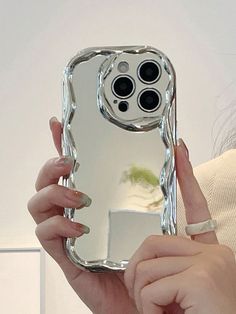 a woman holding up a cell phone case in front of her face with the camera on it