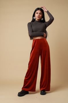 "PLEASE NOTE - Due to these trousers being handmade please allow 14-21 working days to be made and sent. The rust velvet trousers feature a soft 4 way stretch fabric complete an elasticated waistband and wide leg. Lightweight and versatile, perfect to pair with a cosy jumper for those spring walks or the black velvet halter for those festival adventures.. Trousers available in sizes 4,6,8,10,12,14,16,18,20: UK 4 - Waist 21\"- 22\", Hip 34\",  UK 6 - Waist 23\" - 24\", Hip 34\" UK 8 - Waist 25 \" Fall Velvet Wide Leg Pants, Velvet Bottoms For Fall Loungewear, Fall Velvet Trousers, Fall Velvet Bottoms For Loungewear, Fall Velvet Loungewear Bottoms, Fall Velvet Wide Leg Straight Pants, Stretch Velvet Pants For Loungewear, Stretch Velvet Lounge Pants, Cosy Jumper